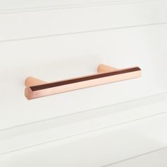 a close up of a door handle on a white wall