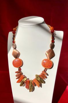 Make your outfit sizzle with this Rustic Flame Necklace. Gold, orange, red hues blend perfectly together. This one of a kind, hand-made necklace is sure to add the perfect amount of glamour to any ensemble. Luxury Handmade Orange Necklaces, Handmade Adjustable Orange Necklace, Adjustable Handmade Orange Necklaces, Red Long Necklace For Party, Unique Red Copper Necklace, Unique Handmade Orange Necklaces, Handmade Unique Orange Necklaces, Handmade Orange Necklace, Handmade Orange Long Necklace