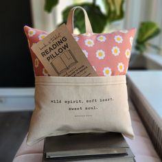 two books are sitting on top of a pillow