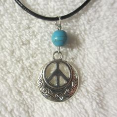 "Peace Sign Necklace -- Single Bead Minimalist Style A great fresh take on an old classic! This is a great looking necklace! Single 8mm Bead -- Choose your gemstone from the List All are Real Stone beads The overall length of the necklace is adjustable with a small chain, approximately 18.25\"-19.75\" range, and the necklace itself is made from 2mm black waxed nylon jewelry cord with crimped end connectors, jewelry hardware, findings, rings, and a lobster clasp closure -- made with the same stuf Adjustable Round Hippie Jewelry, Adjustable Round Charm Necklace Nickel Free, Adjustable Nickel-free Round Charm Necklace, Casual Adjustable Necklace With Round Pendant, Casual Adjustable Jewelry With Round Pendant, Adjustable Hypoallergenic Round Charm Necklace, Adjustable Round Choker For Festivals, Casual Adjustable Round Pendant Necklace, Casual Handmade Round Necklace