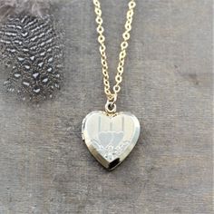 "This vintage locket is engraved with a double heart design on the front; the reverse is plain. The 12k gold filled heart opens revealing two frames in which to place your favorite photos. The locket hangs from a new 14k gold filled cable chain finished tiny gold balls at the lobster clasp closure. Locket 24x20mm Necklace length 18\" (45cm) ✦All of our vintage lockets ship with complimentary insurance✦ ✤Our entire selection of lockets can be found here✤ http://www.etsy.com/shop/LexiandGem?sectio Traditional Heart-shaped Jewelry For Weddings, Traditional Heart Jewelry For Wedding, Traditional Heart-shaped Wedding Jewelry, Heirloom Etched Jewelry For Wedding, Heirloom Etched Wedding Jewelry, Victorian Jewelry With Heart Charm For Anniversary, Heirloom Engraved Locket Necklace For Valentine's Day, Heirloom Engraved Jewelry For Valentine's Day, Vintage Heart Charm Locket Necklace For Wedding