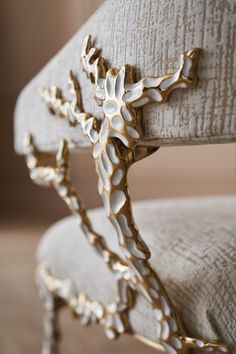 an ornately decorated chair with gold accents