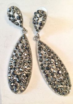 Extra long black crystal dangle drop earrings double teardrop studded with sparkling black crystals in silver tone metal. Stud earrings with push back closures, a large tear drop stud with long tear drop dangle captures the light creating a galaxy of sparkle.  Perfect for party or formal wear.  Measures 3 inches long x 3/4 inches wide, like new preowned condition Free shipping Metal Teardrop Earrings For Evening, Metal Teardrop Pierced Earrings For Party, Pierced Metal Teardrop Earrings For Party, Glamorous Silver Teardrop Earrings For Evening, Silver Drop Teardrop Earrings For Party, Silver Teardrop Earrings For Party, Party Teardrop Pierced Metal Earrings, Party Drop Crystal Earrings With Pierced Detail, Silver Teardrop Earrings With Sparkling Stones For Party