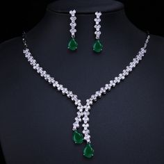 Make a stunning statement with this exquisite jewelry set, featuring a captivating emerald green cubic zircon necklace and earrings. Whether you're attending a wedding, a special event, or simply want to add a touch of sophistication to your ensemble, this set is the perfect choice. Key Features: Designed for the trend-conscious individual Elegant geometric shape and pattern Suitable for weddings and other special occasions Made of high-quality copper and adorned with shimmering cubic zirconia I Cubic Zirconia Necklace For Party, May Birthstone, Green Sparkling Stones Jewelry Sets For Party, Green Crystal Jewelry Sets With Sparkling Stones, Hand Set Emerald Necklace With Cubic Zirconia For Party, Formal Green Bridal Necklace With Sparkling Stones, Hand Set Cubic Zirconia Emerald Necklace For Party, Hand-set Cubic Zirconia Emerald Necklace For Party, Green Diamond Jewelry Set For Party, Green Sparkling Stones Jewelry Sets For Wedding