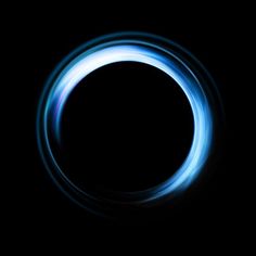 a blue ring in the dark with light coming from it