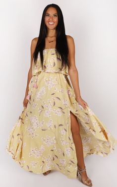 Get ready to bloom in style with our Light Yellow Floral Maxi Dress! This dress features a vibrant floral print. The tie waist with pink tassels adds a playful touch, allowing you to adjust the fit to your preference. With two slits on the side, this dress offers a flirty and breezy feel, perfect for sunny days or special occasions. (model is 5'6 wearing a size medium \\ true to size) Lori Dress, Yellow Floral Maxi Dress, Jennifer Dress, Yellow Maxi Dress, Pink Tassel, Julia Dress, Chantilly Lace, Exclusive Fashion, 50's Dress