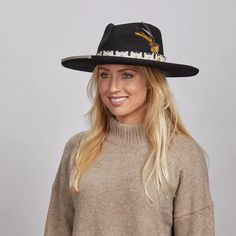 Lounge | Womens Black Pencil Rim Felt Hat exudes a sophisticated yet bold look. Made from firm Australian felt wool with a 4" curled brim, it features a unique fabric trim with twine overlay, faux wood bead, and double feathers, making it perfect for women who want to stand out in style. Material: Midweight Australian Firm Felt Wool Shape: Teardrop Curled Trim: Printed Fabric Band with Twine Overlay, Wood Bead, and Double Feather Brim Size: 4" Crown Height: 4 1/4" Sweatband: AHM Velcro Imported Chic Wool Felt Hat For Fall, Black Wool Felt Hat For Winter, Chic Adjustable Wool Hat Band, Chic Fur Felt Hat For Fall, Black Wool Fedora For Winter, Chic Wool Fedora For Winter, Black Wool Hat For Fall, Chic Winter Wool Fedora, Elegant Flat Brim Hats For Fall