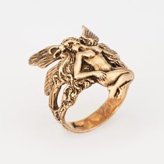 Stylish and finely detailed fairy ring crafted in 14 karat yellow gold.   The ethereal ring depicts a winged fairy in sitting pose. The magical ring makes a nice statement on the hand. The low rise ring (2.2mm - 0.08 inches) sits comfortably on the finger.    The ring is in very good condition. We have not cleaned it in order to preserve the patina and collector value.  Particulars:  Weight: 5.2 grammes  Stones:  N/A   Size & Measurements: The ring is a size 5 (sizable). The band measures 23mm i Gold Statement Rings, Fairycore Rings, Ethereal Gold Rings, Gold Fairy Jewelry, Unique Wedding Rings Boho, Mystical Yellow Gold Ring, Nature Rings, Whimsical Rings, Fairy Rings Jewelry