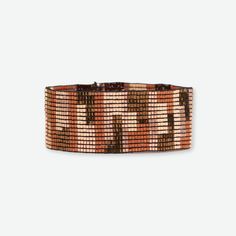 Elevate your style with the Kenzie Blocks Beaded Stretch Bracelet in Apricot and Bronze, a stunning accessory that effortlessly blends warmth and sophistication. This bracelet features a captivating pattern of small beads in rich, earthy tones, creating a mesmerizing mosaic that wraps elegantly around your wrist. The apricot beads, with their soft and inviting hue, are beautifully complemented by the deep, lustrous bronze beads, resulting in a color palette that exudes both comfort and luxury. The intricate arrangement of the beads forms a striking geometric design, reminiscent of ancient tile work and adding a touch of timeless charm to any ensemble. --DETAILS-- 7" (seam to seam), 1" W (stretch) Handmade by skilled artisans in India Hypoallergenic nickel + lead-free brass hardware These a Earthy Brown Beaded Bracelets With Round Beads, Elegant Adjustable Brown Beaded Bracelets, Brown Beaded Stretch Bracelet With Round Beads, Adjustable Brown Beaded Bracelets With Colorful Beads, Adjustable Brown Bracelets With Colorful Beads, Brown Bracelets With Colorful Beads And Adjustable Fit, Colorful Beaded Bracelets With Round Beads, Adjustable Brown Stretch Bracelet With Faceted Beads, Adjustable Brown Stretch Bracelet With Colorful Beads