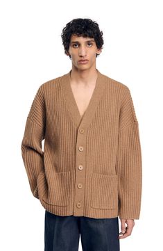 Oversized cardigan in chunky rib knit with full, long sleeves, V-neck, button fastening with tone-on-tone buttons and patch pockets. Sandro Men's oversized cardigan V-neck Long full sleeves 2 patch pockets The model is 6'1 tall and wears a size M Oversized Ribbed V-neck Outerwear, Oversized V-neck Ribbed Outerwear, Classic Wool Oversized Cardigan, Classic Oversized Wool Cardigan, Classic Oversized Ribbed Cardigan, Oversized Ribbed Outerwear, Oversized Ribbed Outerwear For Work, Oversized Wool Casual Cardigan, Casual Wool Ribbed Cardigan