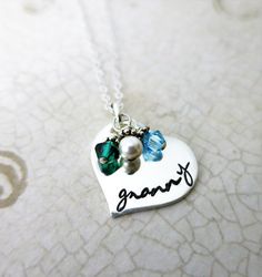 "|ABOUT| ∞ This sweet heart-shaped sterling silver pendant necklace is perfect for celebrating \"nanny\" status! (Or granny, oma, bubbe, bubbie, grams, etc.!) Accented by Bali silver bead topped 4mm bi-cone Swarovski Crystal birthstone drops celebrating each grandchild & adding a pop of color and a little sparkle. |DETAILS| ∞Material: .925 Sterling Silver ∞Finish: Smooth, shiny, inked ∞Chain type: .925 Sterling Silver Cable Chain ∞Length: 16\", 18\", 20\" ∞Measurements: 3/4\" ∞Font default: Heart Shaped Nickel Free Necklace For Birthday, Personalized Silver Heart Necklace In Cute Style, Silver Personalized Cute Heart Necklace, Cute Personalized Silver Heart Necklace, Silver Birthday Name Necklace With Heart Charm, Birthday Silver Name Necklace With Heart Charm, Customizable Heart-shaped Sterling Silver Charm Necklace, Customizable Heart Charm Necklaces, Handmade Heart-shaped Name Necklace For Personalized Gift