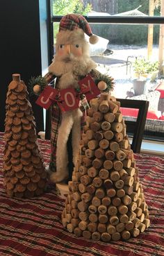 a christmas decoration made out of wine corks with santa clause holding a sale sign