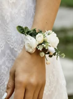 a close up of a person's hand wearing a ring with flowers on it