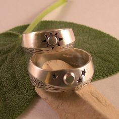 "There is nothing like seeing the moon's glint off water on a peaceful night, and in the morning...the sun is shining. Like Yin and Yang, night and day work together in a circle of life. What wonderful symbols for wedding bands! These rings have a soft brush finish, but could also be done in high polish. I have used oxidation, or antiquing to bring out the details. The width varies slightly in the design of both rings, which gives a truely custom feel. Both rings measure in width about 5/16\" wi Celestial Style Engraved Jewelry For Wedding, Celestial Style Engraved Wedding Jewelry, Mystical Engraved Wedding Jewelry, Mystical Moon Phase Ring For Anniversary, Celestial Rings With Sun And Moon Design For Anniversary, Celestial Sun And Moon Design Rings For Anniversary, Engraved Moon Shaped Jewelry For Wedding, Engraved Moon Shaped Wedding Jewelry, Mystical Sun And Moon Design Jewelry For Wedding