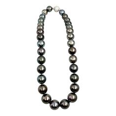 This beautiful and elegant natural Tahitian black pearl necklace features 99 diamonds weighing 2.83 ct set in 18k white gold. The pearls are between 12 mm and 15.80 mm thick. A stunning piece to add to any wardrobe. Black High Luster Necklace For Formal Occasions, Formal Black High Luster Necklaces, Formal High Luster Black Necklace, Luxury Tahitian Pearl Necklace For Formal Occasions, Formal Black High Luster Necklace, Classic Tahitian Pearl Necklace In White Gold, Formal Black Tahitian Pearl Necklaces, Formal Black Tahitian Pearl Jewelry, Classic White Gold Tahitian Pearl Necklace