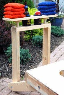 an outdoor table with towels and bottles on it