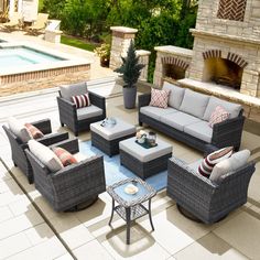 an outdoor living room with couches, chairs and a table next to a pool