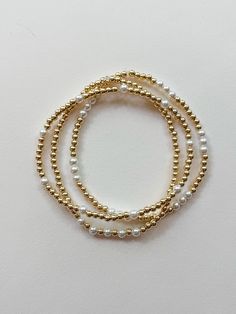 these super sweet and dainty gold and pearl bracelets are perfect for everyday wear! each one is custom made just for YOU! select your size and choose your style from the options shown. PLEASE NOTE: you will receive ONE bracelet with this order unless you choose the option for the set of all three. MADE WITH GOLD FILL BEADS - "gold fill" beads are high quality and they don't tarnish or fade like "gold plated" beads. the difference is a long-lasting premium piece of jewelry that is perfect for everyday wear. these super trendy and versatile stretch bracelets are the perfect little accessory for your wrist. they are dainty and beautiful by themselves, but also look great when combined and stacked. you can add to your stack right here: http://www.etsy.com/shop/letterhappy?section_id=7484094 t Dainty 14k Gold-filled Stretch Bracelet, Pearl And Gold Bracelet, Gold Stacked Bracelets, Gold And Pearl Bracelet, Neutral Jewelry, Gold Bead Bracelet, Preppy Jewelry, Pearl Bracelets, Circle Bracelet