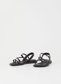 Elevate your everyday look with Izzy, the strappy sandals that exude minimalistic elegance. Crafted from luxurious black leather, these sandals feature a slanted toe shape and double adjustable straps with buckle fastening for the perfect fit. The molded outsoles with 20mm heels provide both comfort and style, while the padded insoles add an extra touch of luxury. Step into sophistication with Izzy. Black leather Slanted toe shape Adjustable ankle straps Padded insoles 20mm heels Vagabond Shoes, Cream Shoes, Black Leather Sandals, Shoes Flats Sandals, Orange Leather, Boot Bag, Leather Silver, Ankle Straps, Metallic Leather