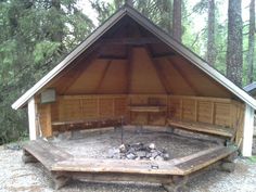 an outdoor fire pit in the middle of a forest