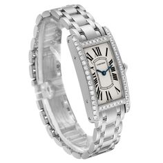 Cartier Tank Americaine White Gold Diamond Ladies Watch WB7073L1. Quartz movement. 18K white gold case 19.0 x 35.0 mm. Octagonal crown set with original Cartier factory faceted diamond. . Scratch resistant sapphire crystal. Silvered grained dial with black Roman numeral hour markers and an inner minute track. Sword-shaped blued steel hands. 18K white gold bracelet with hidden butterfly clasp. Fits a 6" wrist. Classic Diamond White Watch With Brilliant Cut, Classic Diamond Accented Watch For Anniversary, Classic Diamond White Jewelry And Watches With Brilliant Cut, Classic Wedding Jewelry And Watches With Diamond Hour Markers, Luxury Cartier Diamond Watch With Diamond Accents, Cartier Luxury Diamond Watch For Wedding, Classic Platinum Diamond Watch With Brilliant Cut, Cartier Jewelry With Diamond Hour Markers, Cartier Diamond Watch For Wedding