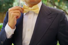 OTAA's elder brother, Mr. Haroon, attributes the brand's impeccable tailoring of their Light Yellow Satin Bow Tie to "a combination of cut, cloth and attention to detail." From its subtly smooth satin and dapper sheen feel to the elegantly slim fit, the OTAA Light Yellow Satin Pre-tied bowtie excels on all three counts. Handcrafted, this style is finished with smooth, satin-blend lining and internal stitching for complete robustness. Wear it against a stark white shirt to play up the rich hue. Tailored Satin Suits For Formal Occasions, Tailored Satin Tuxedo For Business, Tailored Satin Suits For Semi-formal Occasions, Classic Tailored Satin Suits, Tailored Satin Suit For Semi-formal Occasions, Tailored Satin Semi-formal Suits, Spring Fitted Tuxedo For Formal Occasions, Spring Formal Fitted Tuxedo, Classic Satin Suits For Semi-formal Occasions