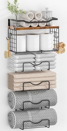 a shelf with towels, plates and cups on it in front of a white wall