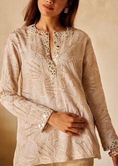 The tunic embodies a relaxed fit top with a plunging neckline with detailed mirrorwork and beadwork. Festive V-neck Kurta With Intricate Embroidery, Embellished V-neck Kurta For Party, Festive Embellished Straight Kurta Top, Bohemian V-neck Top With Resham Embroidery, Festive Embellished V-neck Kaftan, Elegant V-neck Kurta With Resham Embroidery, Embellished Summer Tunic Kurta, Summer Embellished Tunic Kurta, Embellished Tunic Kurta For Summer