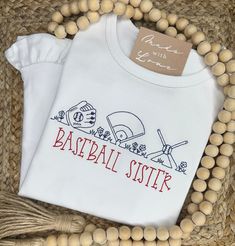 Hey, batter batter! This baseball shirt is perfect for your favorite little fan! This design looks great with or without a monogram! When ordering an embroidered item, please specify your monogram initials or name, monogram font & thread color. All of the monogram options can be found here. Also, please note any special requests in the box provided. We will try our best to comply. Personalized White Sporty T-shirt, Personalized Cotton T-shirt For Game Day, Collegiate White Tops With Custom Embroidery, White Collegiate Top With Custom Embroidery, White Varsity T-shirt With Embroidered Graphics, White Sporty T-shirt With Custom Embroidery, White Personalized Team Spirit Top, Personalized White Tops For Game Day, Personalized Team Spirit Cotton Tops