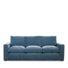 a blue couch sitting on top of a white floor