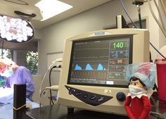 an elf is sitting in front of a medical monitor