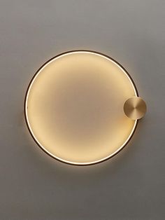 a round light fixture mounted on the wall