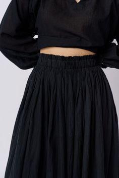 Experience effortless style with this breezy monochrome skirt. Crafted from soft and smooth handwoven cotton, it features a swingy fit and a flattering midi length. Designed to sit high on the waist, it showcases a smocked elasticated waistband and graceful gathers for a voluminous flare. Casual Midi Bottoms With Gathered Waist, Casual Bottoms With Gathered Waist, Midi Length, Casual Midi-length Bottoms With Gathered Waist, Spring Maxi Skirt With Elastic Waistband For Daywear, Casual Midi Skirt With Gathered Waist, Casual Midi Length Skirt With Gathered Waist, Spring Maxi Skirt With Gathered Waist, Spring Midi Skirt With Gathered Waist, Chic Midi Bottoms With Gathered Waist