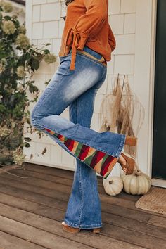 Stay groovy this fall with our 'Amy' pants featuring a medium wash denim material with accent fading and a colorful embroidery design on the back and down the flares! These retro bottoms will take you from season to season, it has a hidden zip fly with a button closure and belt loops, two pockets in the front, none in the back, and a very flattering silhouette that ends in straight floor-length hemlines. Measurements S : Front Rise 10", Hip 30", Inseam 33.5", Length 43", Waist 24". M : Front Ris Model Fits, Hip Length, Bell Bottom Jeans, Floor Length, Embroidery Designs, Luxury Fashion, Fashion Trends, Pants, Color