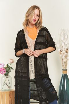 This half-sleeve crochet open cardigan exudes bohemian charm and effortless style. Crafted from a blend of 65% acrylic and 35% cotton, it offers a lightweight and breathable feel, perfect for layering in any season. The crochet detailing adds a delicate and feminine touch, elevating the cardigan's aesthetic appeal. With its open front design, this cardigan is versatile and easy to style, making it a staple piece in your wardrobe. Whether you're layering it over a simple top and jeans for a casual daytime look or pairing it with a dress for a more polished ensemble, this cardigan adds a touch of texture and elegance to any outfit. Its half sleeves provide just the right amount of coverage, making it suitable for transitioning between seasons. Embrace effortless boho-chic style with this cro Casual Fall Cover-up For Layering, Trendy Black Cardigan For The Beach, One Size Open Knit Cardigan For Layering, Trendy Spring Festival Cardigan, Pointelle Knit Cardigan For The Beach, Chic Open Knit Cover-up For Spring, Casual Pointelle Knit Cardigan For The Beach, Beach Pointelle Knit Cardigan, Lightweight Casual Fall Cover-up