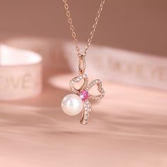 This clover shaped pendant captures the essence of romance with its beautiful design and intricate details. Nestled beneath the bow, a lustrous pearl symbolizes the precious moments shared. Grace your beloved with a gift as rare and captivating as your love. Let this necklace be a testament to the beauty that blossoms when hearts dance together.Carat Weight: 5.093 ctStone Size: 1,1.2,1.5,1.8,8,4.0 mmStone Type: Jeulia® StoneNumber of Stones: 42 Stone Color: Diamond White, FuchsiaStone Shape: Rou Pearl Necklaces With Bow For Wedding, Elegant Flower Pendant Necklaces For Valentine's Day, Elegant Flower Pendant Necklace For Valentine's Day, Formal Bow Jewelry For Valentine's Day, Valentine's Day Formal Bow Jewelry, Wedding Heart-shaped Jewelry With Bow, Elegant Bow Necklace For Anniversary, Elegant Bow Necklace For Valentine's Day, Elegant Bow Jewelry For Valentine's Day