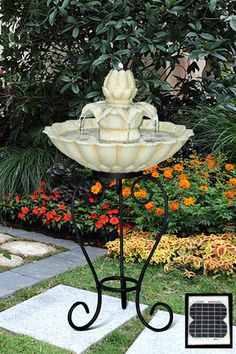 a water fountain in the middle of a garden