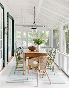 a dining room table with chairs and a potted plant on top of the table