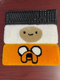 a computer mouse pad with a cartoon character on it and a keyboard in the background