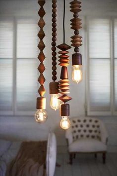 a chandelier made out of wood and lights hanging from it's sides