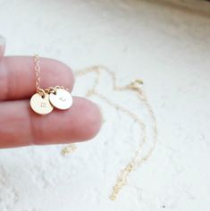 "Tiny Gold Initial Necklace This delicate little initial is hand stamped on a tiny gold filled charm {8mm}. It is customized for you with an initial of your choice. It adorns a 14kt gold filled shimmering link chain. Select up to 4 charms for your necklace! D E T A I L S -Choose from 1-4 tiny discs -Disc measures 8mm - 14kt Gold-Filled discs and necklace -A high quality delicate link chain with a spring clasp. -Polished to a light satin finish. CUSTOM HAND STAMPING -Hand stamped with an initial. Minimalist 14k Gold Hand Stamped Charm Necklace, Dainty Hand Stamped Charm Necklaces For Everyday, Dainty Hand Stamped Charm Necklace For Everyday, Dainty Hand Stamped 14k Gold Charm Necklaces, Personalized Delicate 14k Gold-filled Charm Necklaces, Minimalist Personalized 14k Gold Filled Charm Necklaces, Personalized Delicate 14k Gold-filled Charm Necklace, Dainty 14k Gold Charm Necklaces For Personalized Gift, Dainty 14k Gold Charm Necklace For Personalized Gift