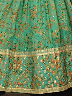 Real beauty comes out from your dressing style with this beautiful green color lehenga assembled with organza material performed with thread embroidery, sequins work, floral print, and dori work. This green lehenga comes with a similar color art silk material choli created with digital print and embroidery. It also comes with a similar color organza material dupatta made with lace border and sequins work. This wonderful green floral printed lehenga is semi-stitched can fit up to 42 inches and co Green Floral Embroidered Sharara For Navratri, Green Sharara With Floral Embroidery For Navratri, Green Bollywood Style Sharara With Floral Print, Bollywood Style Green Floral Sharara, Traditional Pista Green Anarkali Set With Floral Print, Floral Print Dupatta For Diwali Reception, Festive Pista Green Anarkali Set With Floral Print, Festive Pista Green Salwar Kameez With Floral Print, Green Floral Embroidery Sets For Diwali