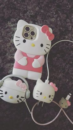 an iphone case with hello kitty on it and two headset plugged into the phone