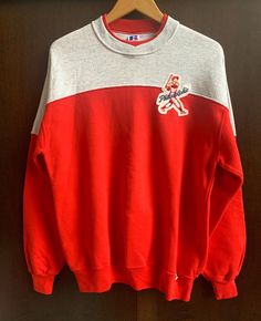 Fantastic Red & Gray, vintage Russell Athletic colorblock crewneck, Made in USA. Upcycled with 1 sewn, vintage original 'Philadelphia' patch on Left Chest. Tagged Size XL mens/unisex and fits as a Large/XL. Sweatshirt is very good, vintage condition, with expected pilling and no stains, wear or tear. Go Phils! Shipped via USPS Priority. Red Patchwork Sweatshirt For Streetwear, Varsity Crew Neck Color Block Top, Varsity Style Crew Neck Color Block Top, Retro Crew Neck Sweatshirt With Ribbed Cuffs, College Crew Neck Tops With Patchwork, Crew Neck Patchwork Tops For College, Vintage Sweatshirt With Ribbed Cuffs For Sports, Red Crew Neck Top With Embroidered Logo, Retro Color Block Crew Neck Sweatshirt