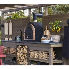 an outdoor kitchen is shown with wood logs