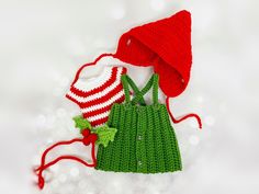 a crocheted green dress and red hat are on the cover of a card