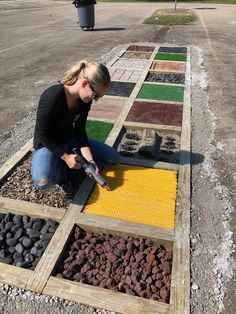 a woman kneeling down on the ground working on something