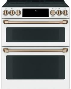 two white and gold ovens side by side