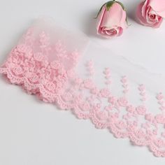 two pink roses and one white lace with the word meete written on it next to each other