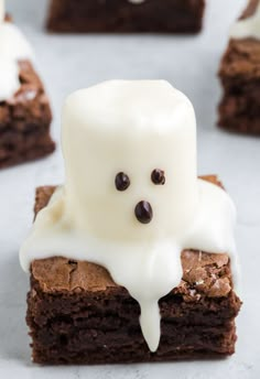 chocolate brownies with white icing and ghost face on top